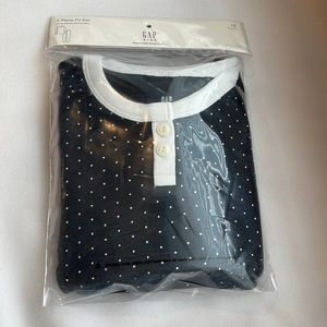 Brand new in packaging girls Gap pajama set size 12. It is black with white dots